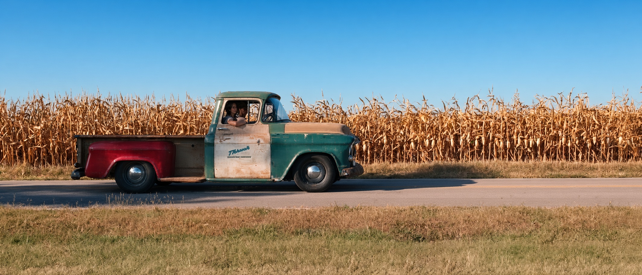 Vintage Thrush & Son company truck driving along a rural Ohio road beside a cornfield