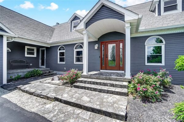 Modern gray home exterior with white trim and upgraded siding showcasing popular siding colors in 2021