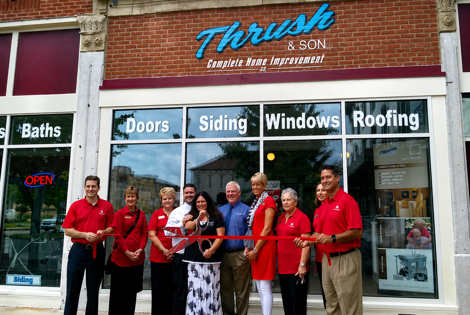 Family-owned Thrush & Son team celebrating ribbon cutting outside their Troy showroom offering roofing, siding, windows, doors, and baths.