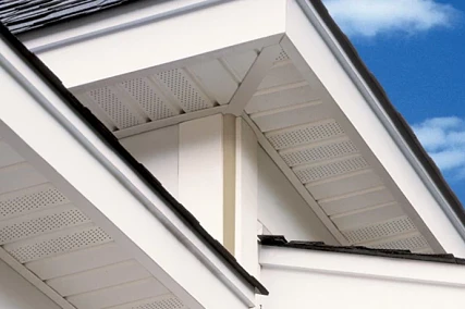 Soffit installation with vented vinyl panels providing proper attic airflow and a clean, finished roof overhang
