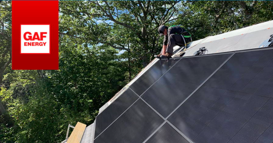 GAF Solar roof installation in progress with technician securing integrated solar panels as part of a residential solar glossary guide.