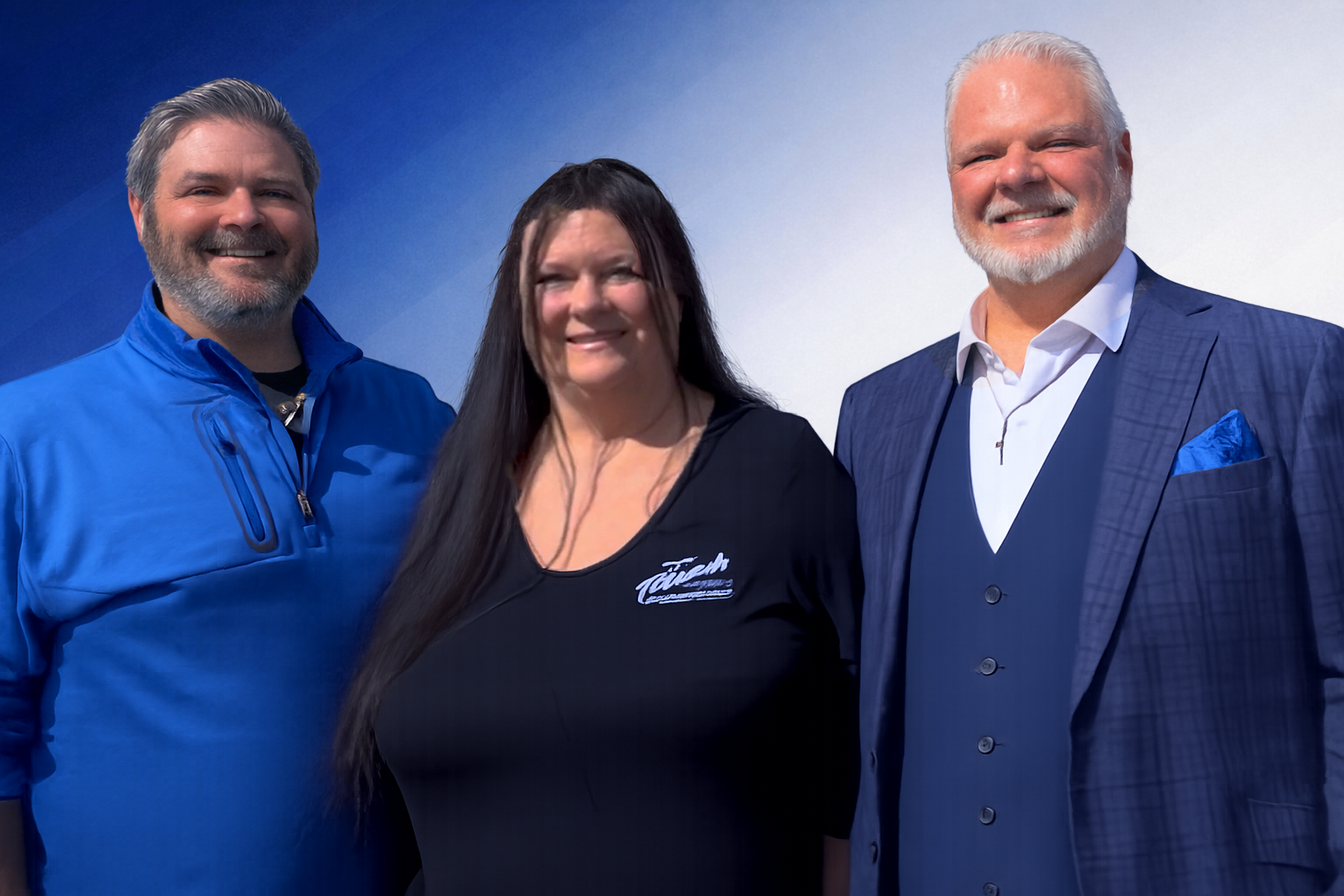 From left to right, Corey A. Thrush, Michelle Thrush, and W. Allen Thrush of Thrush & Son standing together and smiling against a blue and white background.