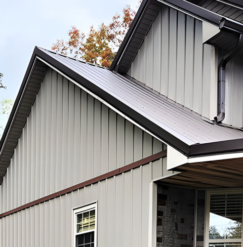 Exterior wall vent properly installed through vinyl siding near roofline of a residential home