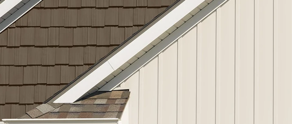 Close-up of vertical vinyl siding installed on a gable with clean trim and precise alignment.