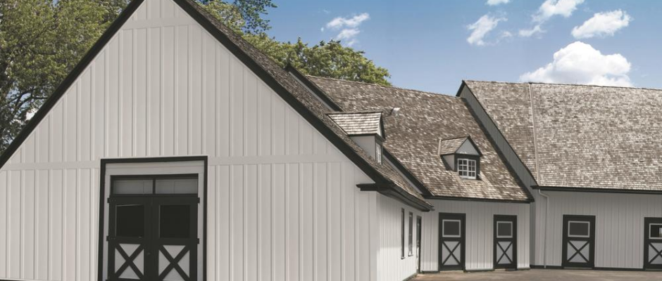 Barn-style building featuring vertical vinyl siding with clean lines and durable finish.