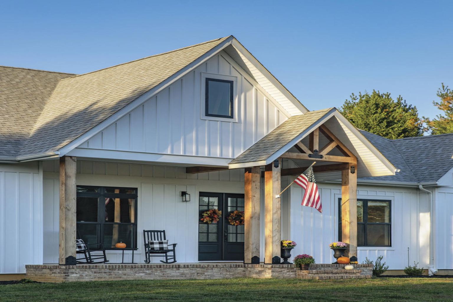 Resource Hub: Farmhouse-style home featuring vertical vinyl siding with board and batten appearance.
