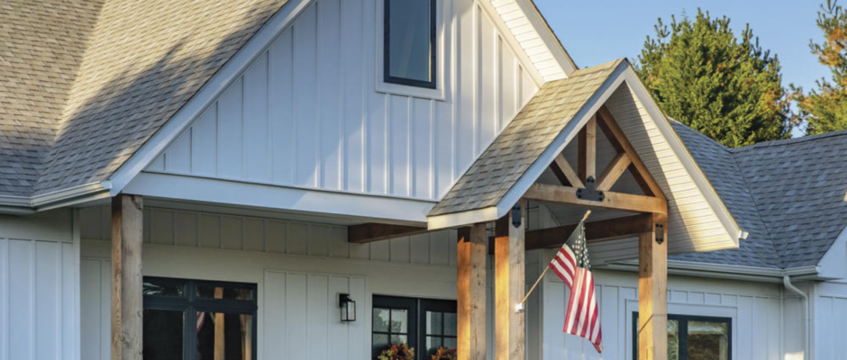 Farmhouse-style home featuring vertical vinyl siding with board and batten appearance.