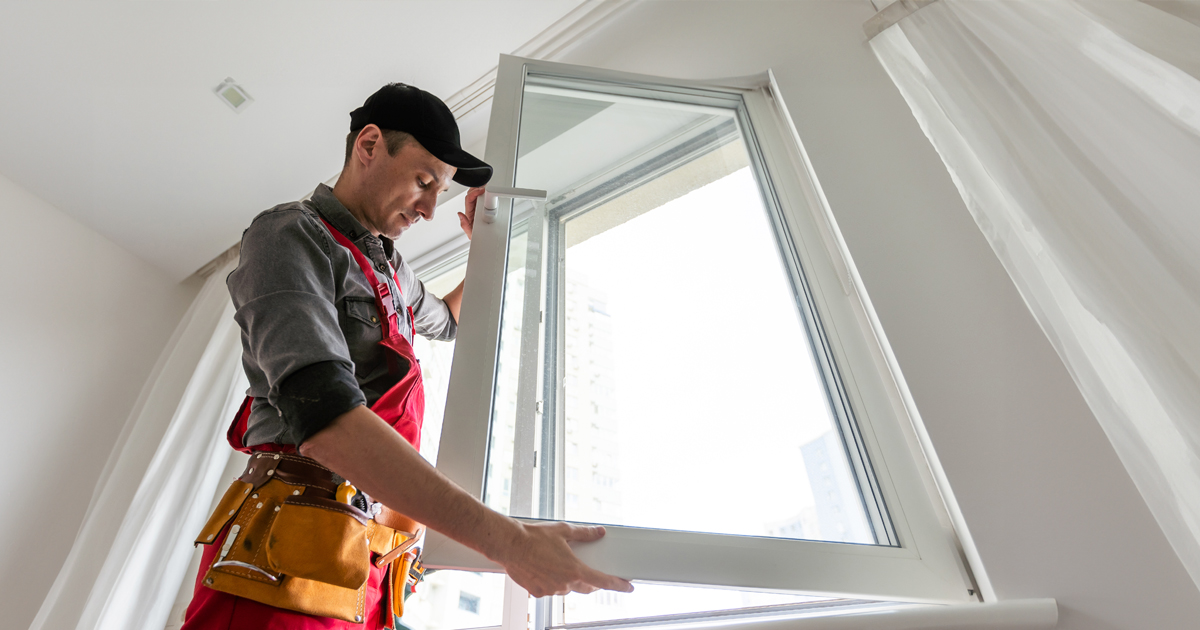 Technician installing a residential window demonstrating proper fit and sealing as part of window & doors terminology concepts