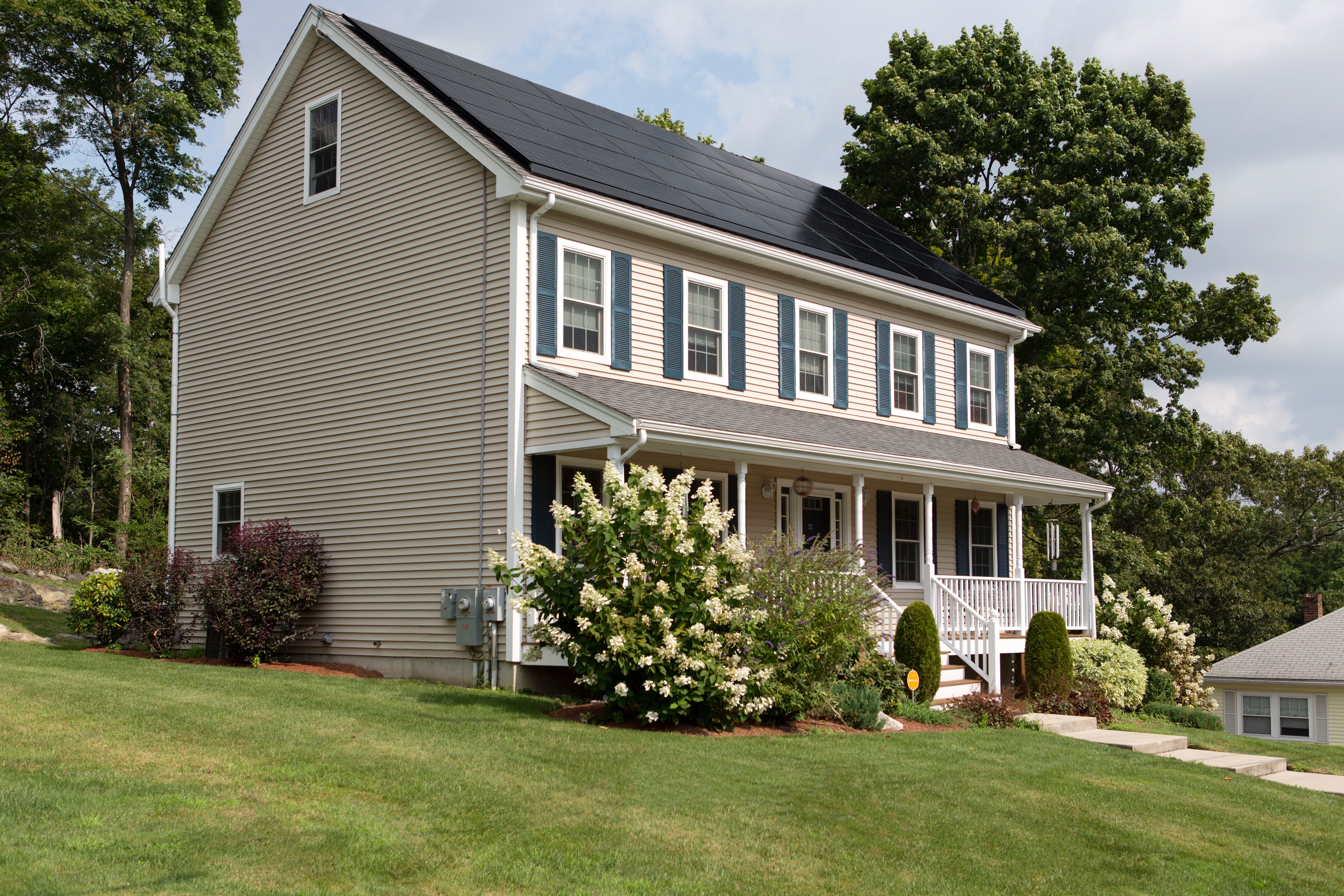 Modern home with solar panels and vinyl siding