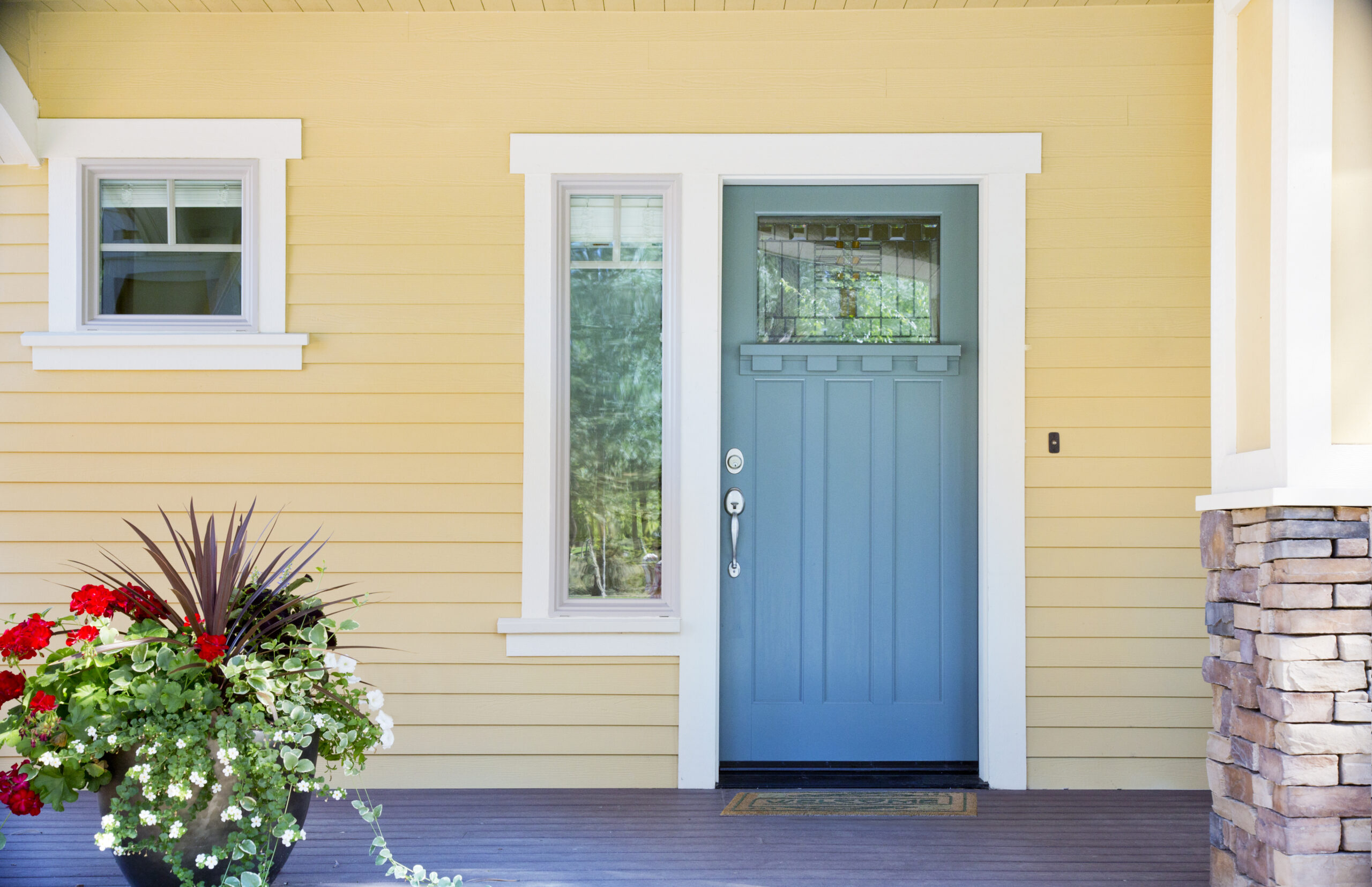 Entry Door replacement in Dayton, Ohio featuring a blue wood-look front door with decorative glass and sidelight